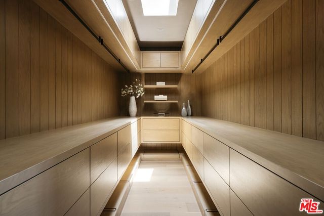 a view of a storage and utility room with washer and dryer