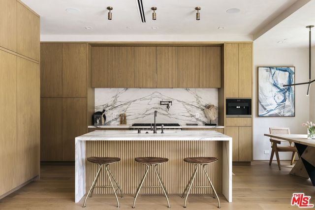 a living room with furniture fireplace and a large window