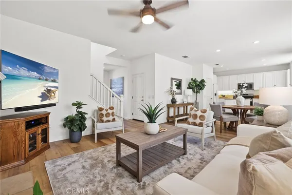 a living room with furniture flat screen tv and a fireplace