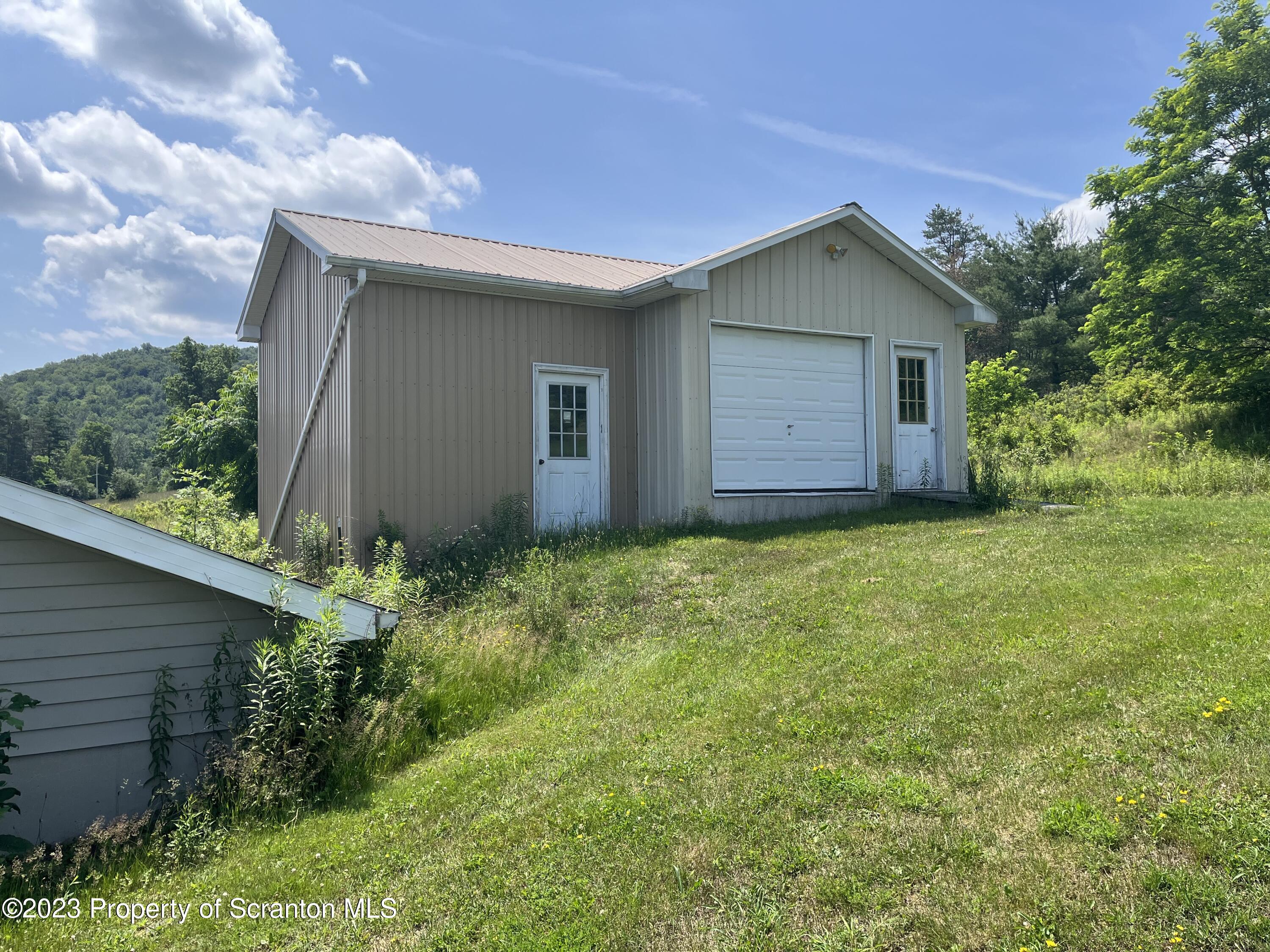 14651 Highway 858 Little Meadows, PA 18830 - Photo 11 of 51 a backyard of a house with plants and large tree