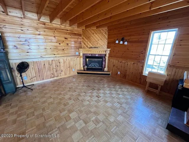 a living room with furniture a rug and a window