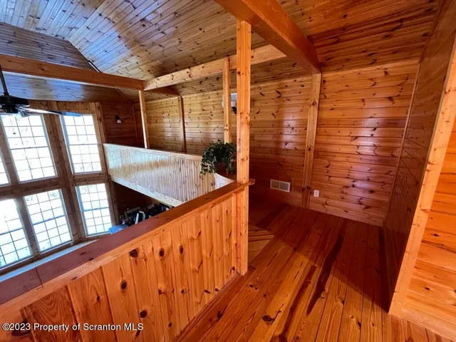 a bedroom with a bed table chair and a window
