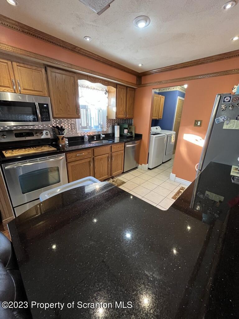 14651 Highway 858 Little Meadows, PA 18830 - Photo 27 of 51 a kitchen with stainless steel appliances a sink stove and refrigerator