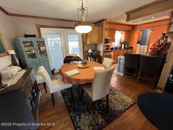 a kitchen with white cabinets and sink