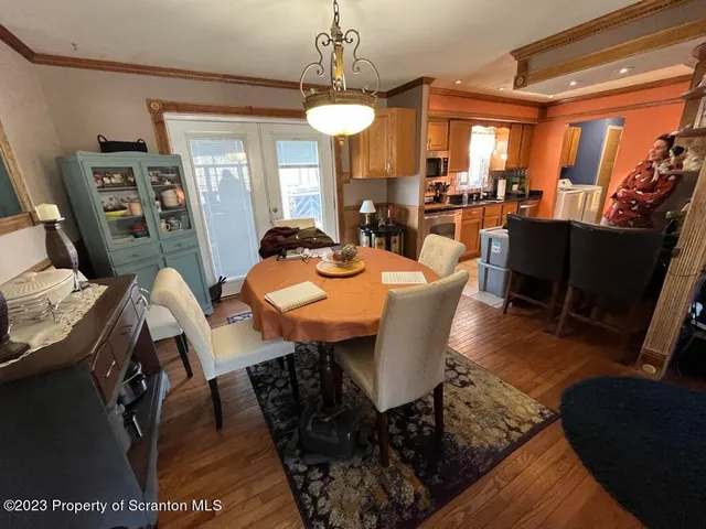 a kitchen with white cabinets and sink