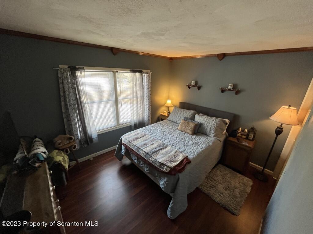 14651 Highway 858 Little Meadows, PA 18830 - Photo 35 of 51 a bedroom with a bed table chair and a window