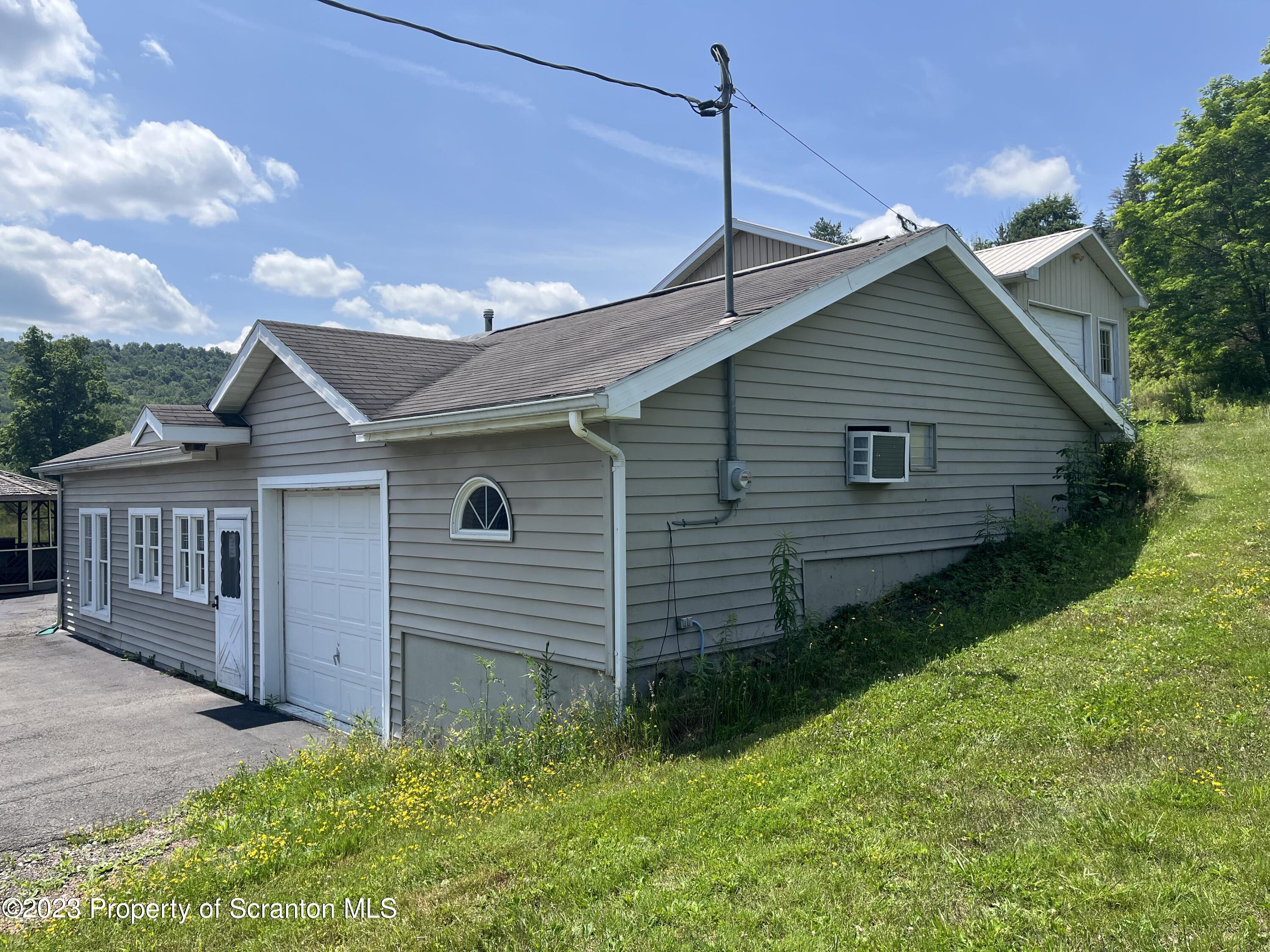 14651 Highway 858 Little Meadows, PA 18830 - Photo 4 of 51 a front view of a house with garden