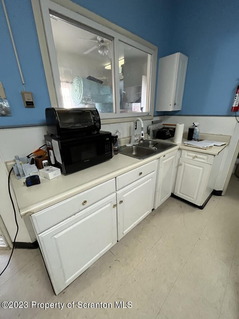 14651 Highway 858 Little Meadows, PA 18830 - Photo 44 of 51 a kitchen with white cabinets and sink