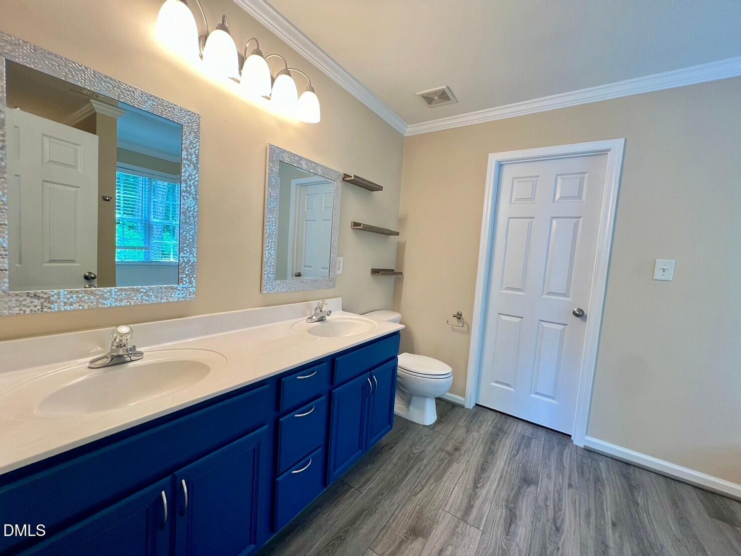 9912 Layla Avenue Raleigh, NC 27617 - Photo 11 of 25 a bathroom with a double vanity sink and mirror with shower