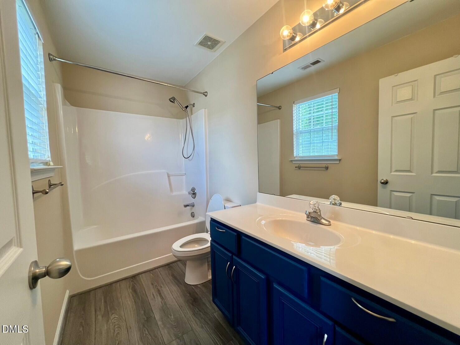 9912 Layla Avenue Raleigh, NC 27617 - Photo 16 of 25 a bathroom with a sink a toilet and shower