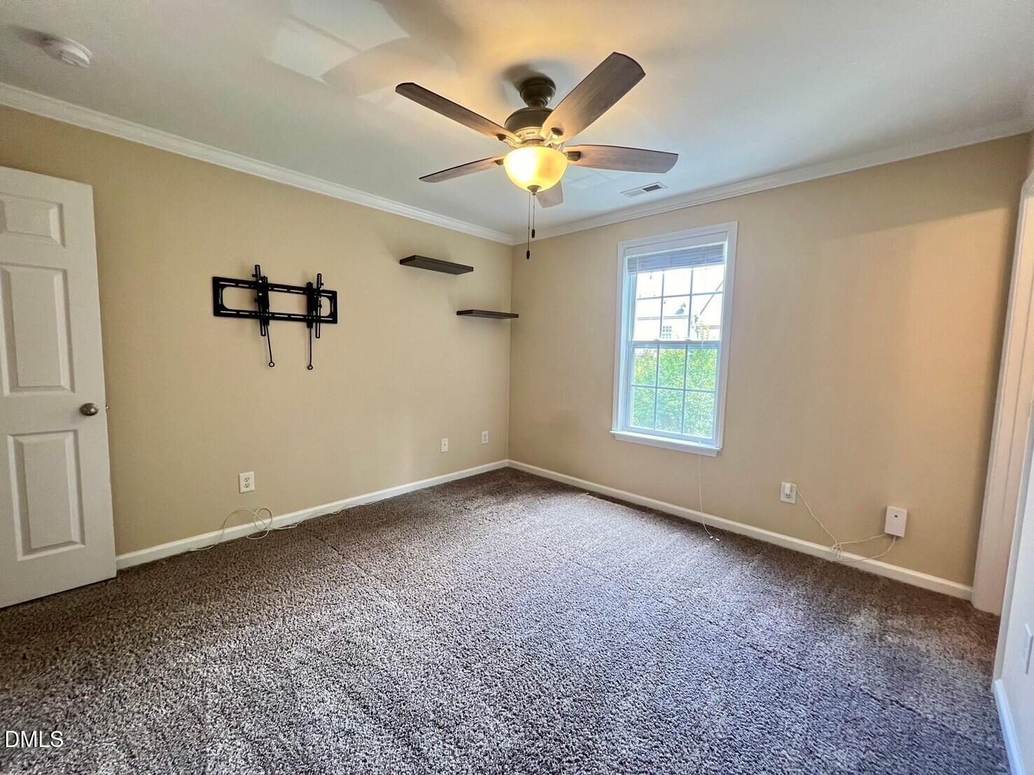 9912 Layla Avenue Raleigh, NC 27617 - Photo 18 of 25 a view of an empty room with a window