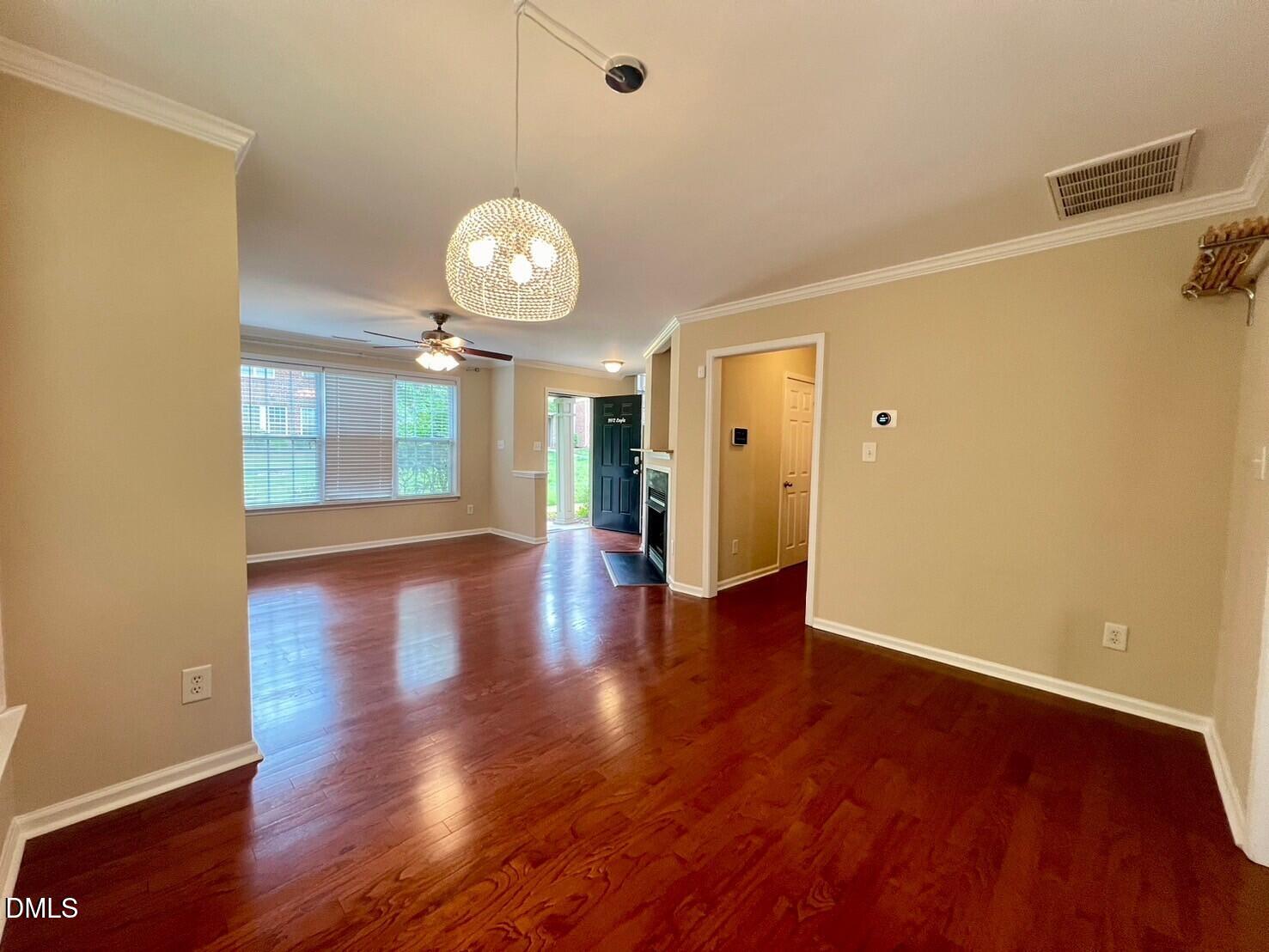 9912 Layla Avenue Raleigh, NC 27617 - Photo 5 of 25 a view of a room with wooden floor and large window