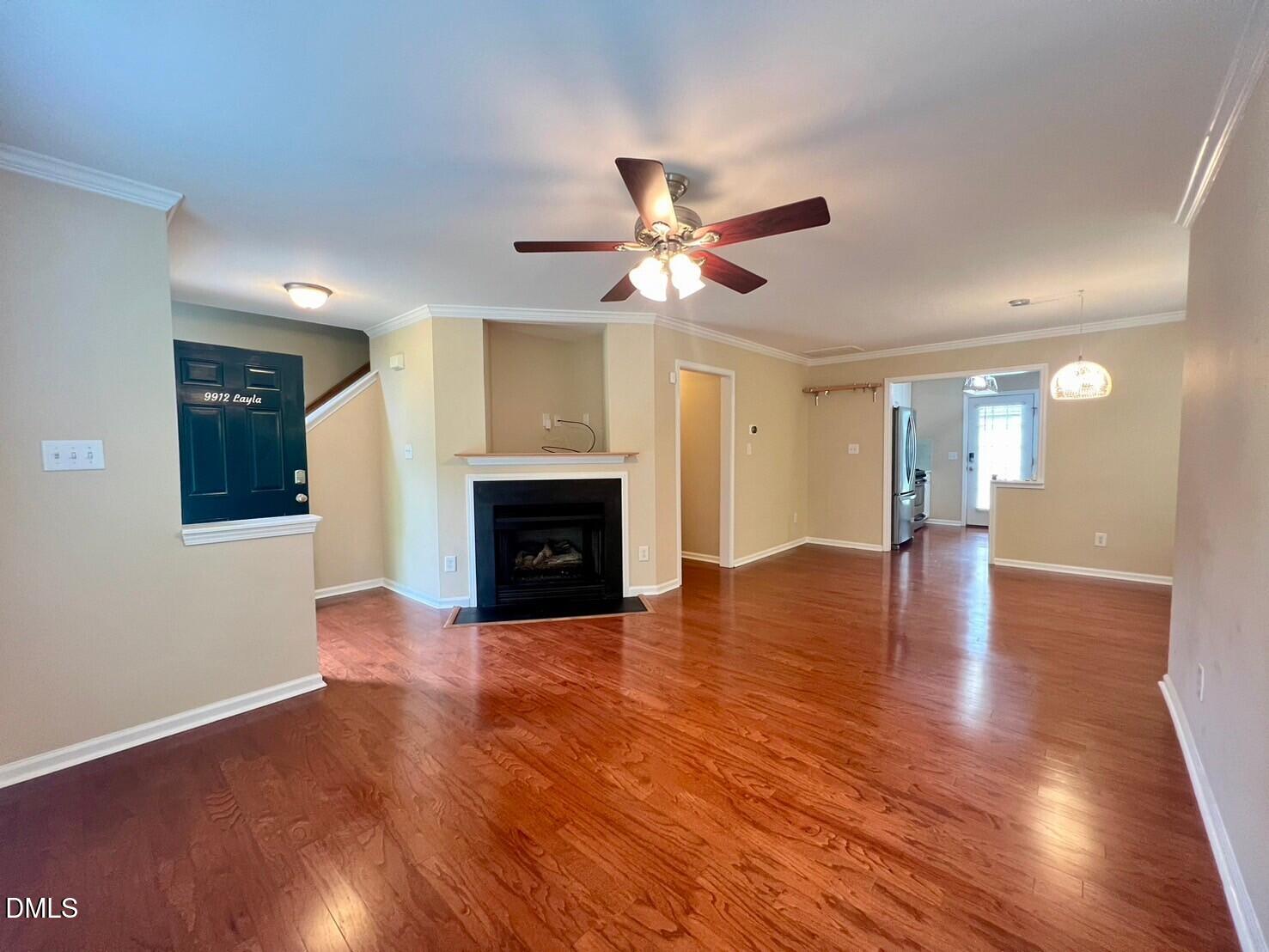 9912 Layla Avenue Raleigh, NC 27617 - Photo 7 of 25 a view of empty room with wooden floor and fireplace