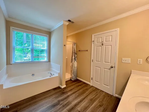 a bathroom with a bathtub and a shower