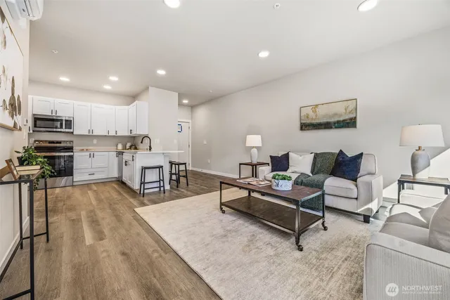 a living room with furniture and kitchen view