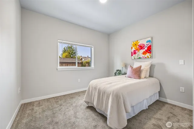 a bedroom with a bed and a painting on the wall