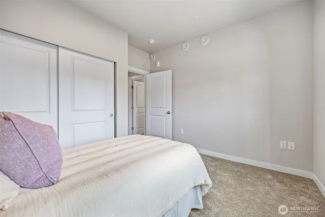 a bedroom with a bed and closet