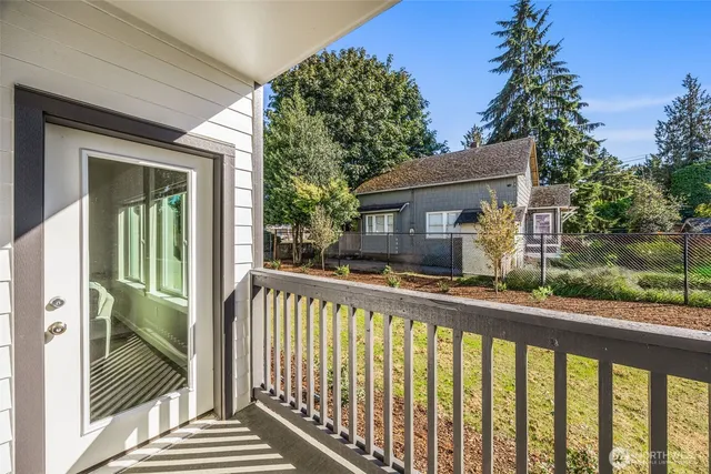 a view of a house with a porch next to a yard