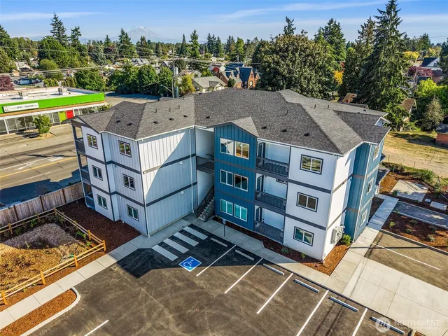 an aerial view of a houses with a yard