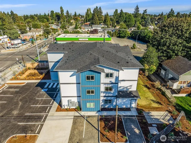 a view of a house with a swimming pool and a yard