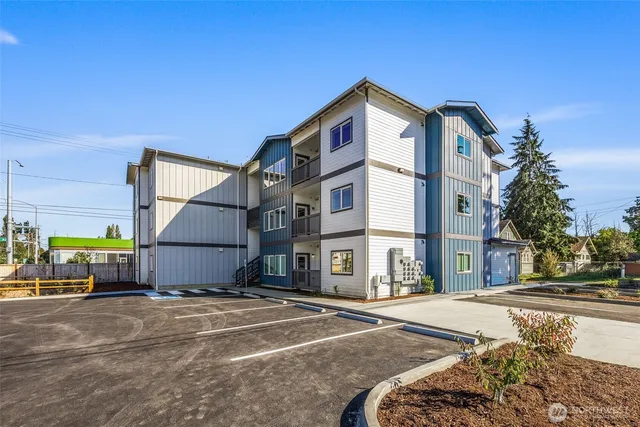 a view of a tall building next to a road