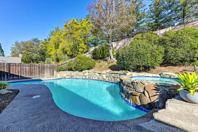 a view of a backyard with swimming pool