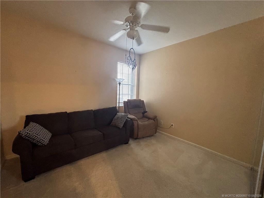 262 Southwest Walking Path, Unit 262 Stuart, FL 34997 - Photo 35 of 39 a living room with furniture and a chandelier