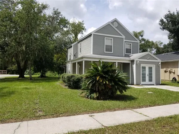 a front view of a house with a yard