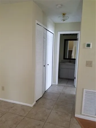 a view of a hallway to rooms
