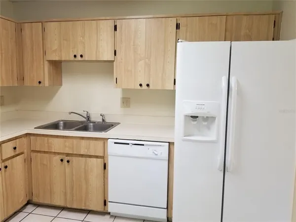 a kitchen with a refrigerator and a sink