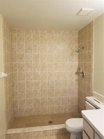a bathroom with a shower a toilet and sink