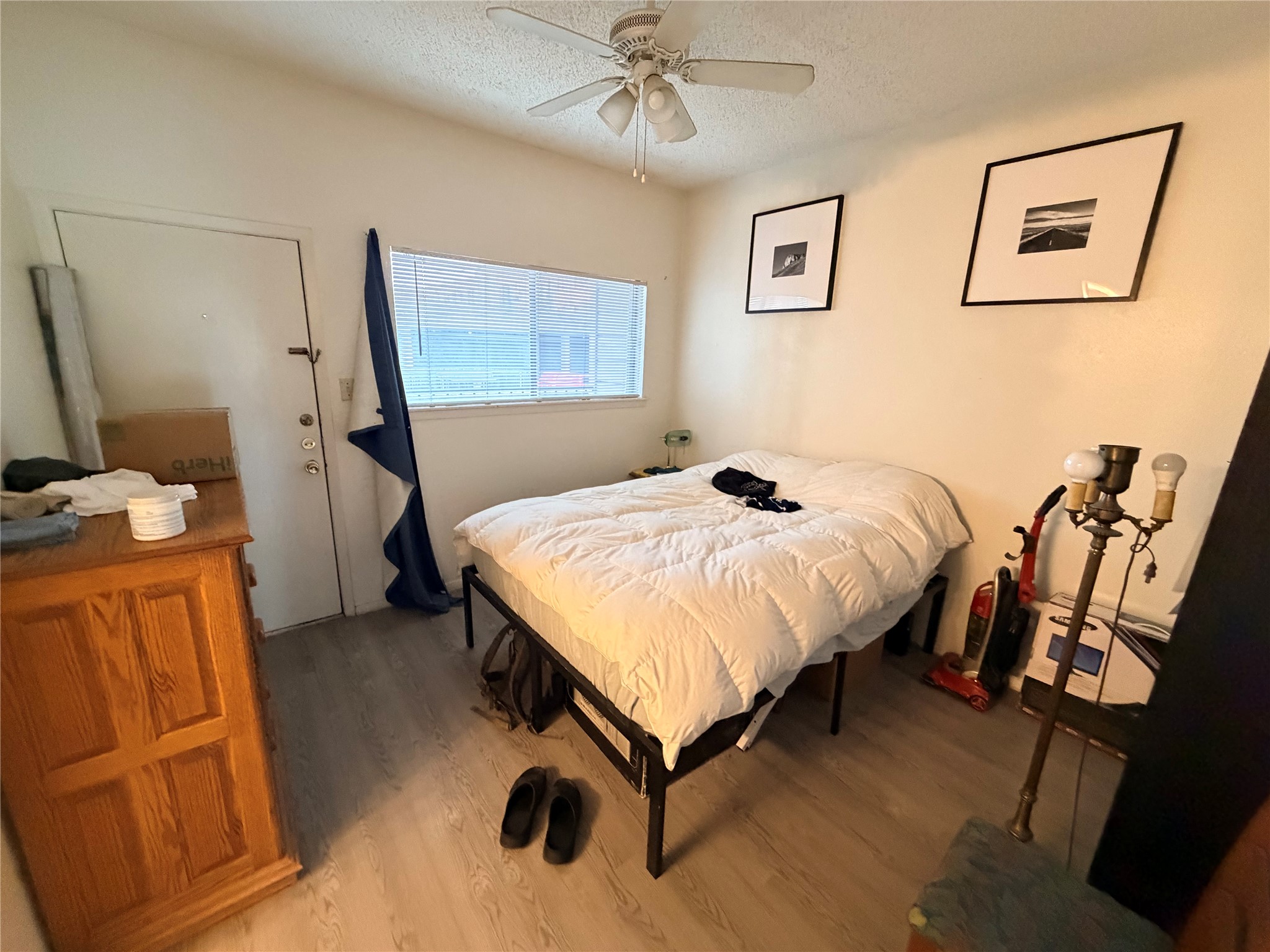 3000 Guadalupe Street, Unit 106 Austin, TX 78705 - Photo 4 of 9 a bedroom with a bed and a flat tv screen on the table