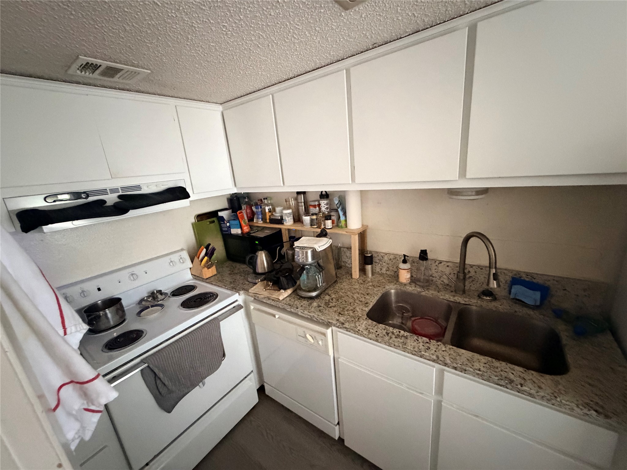 3000 Guadalupe Street, Unit 106 Austin, TX 78705 - Photo 7 of 9 a kitchen with sink a microwave and cabinets