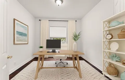 a living room with furniture a flat screen tv and a large window
