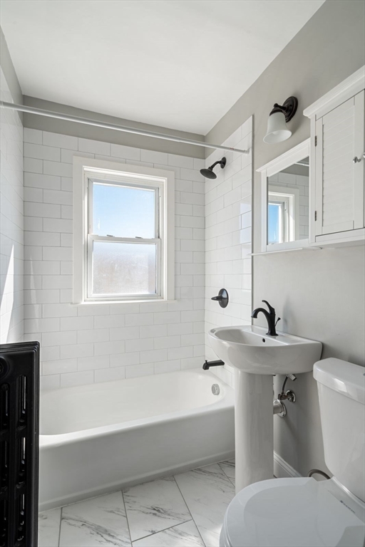 10 Centre Avenue, Unit 5 Boston, MA 02124 - Photo 14 of 24 a bathroom with a sink mirror toilet and bathtub