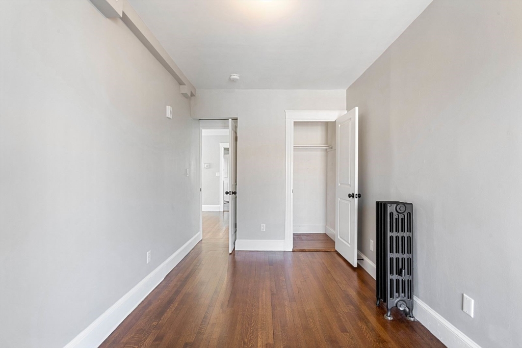 10 Centre Avenue, Unit 5 Boston, MA 02124 - Photo 9 of 24 a view of hallway with wooden floor