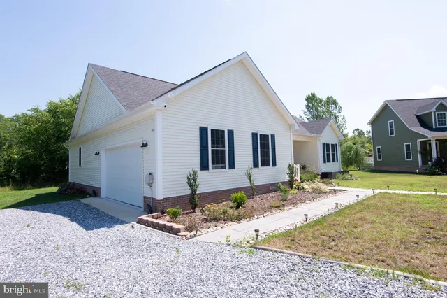 a front view of house with yard outdoor seating and pathway