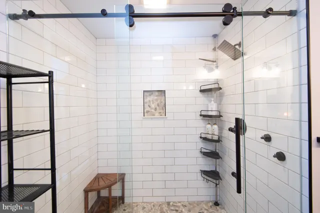 a bathroom with a shower and a mirror