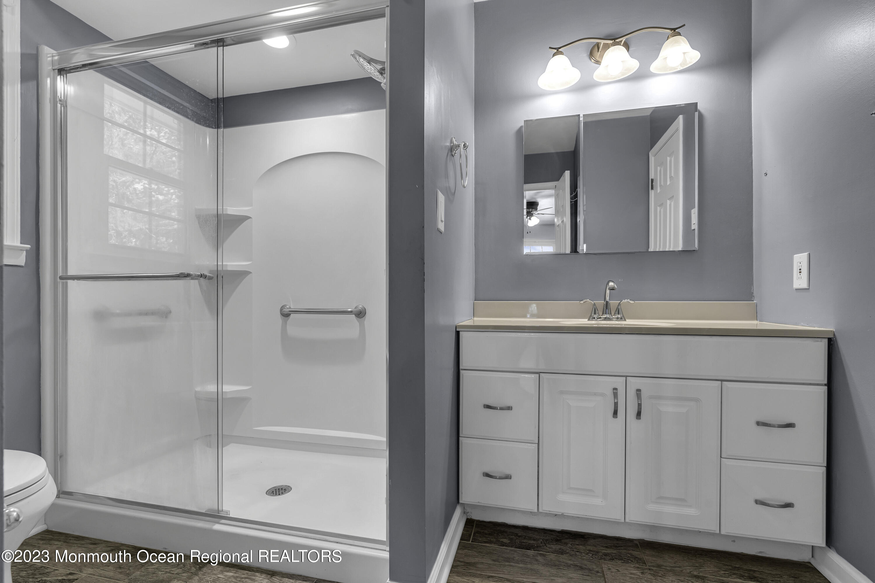 44 Danemar Drive Matawan, NJ 07747 - Photo 18 of 31 a bathroom with a shower sink and mirror