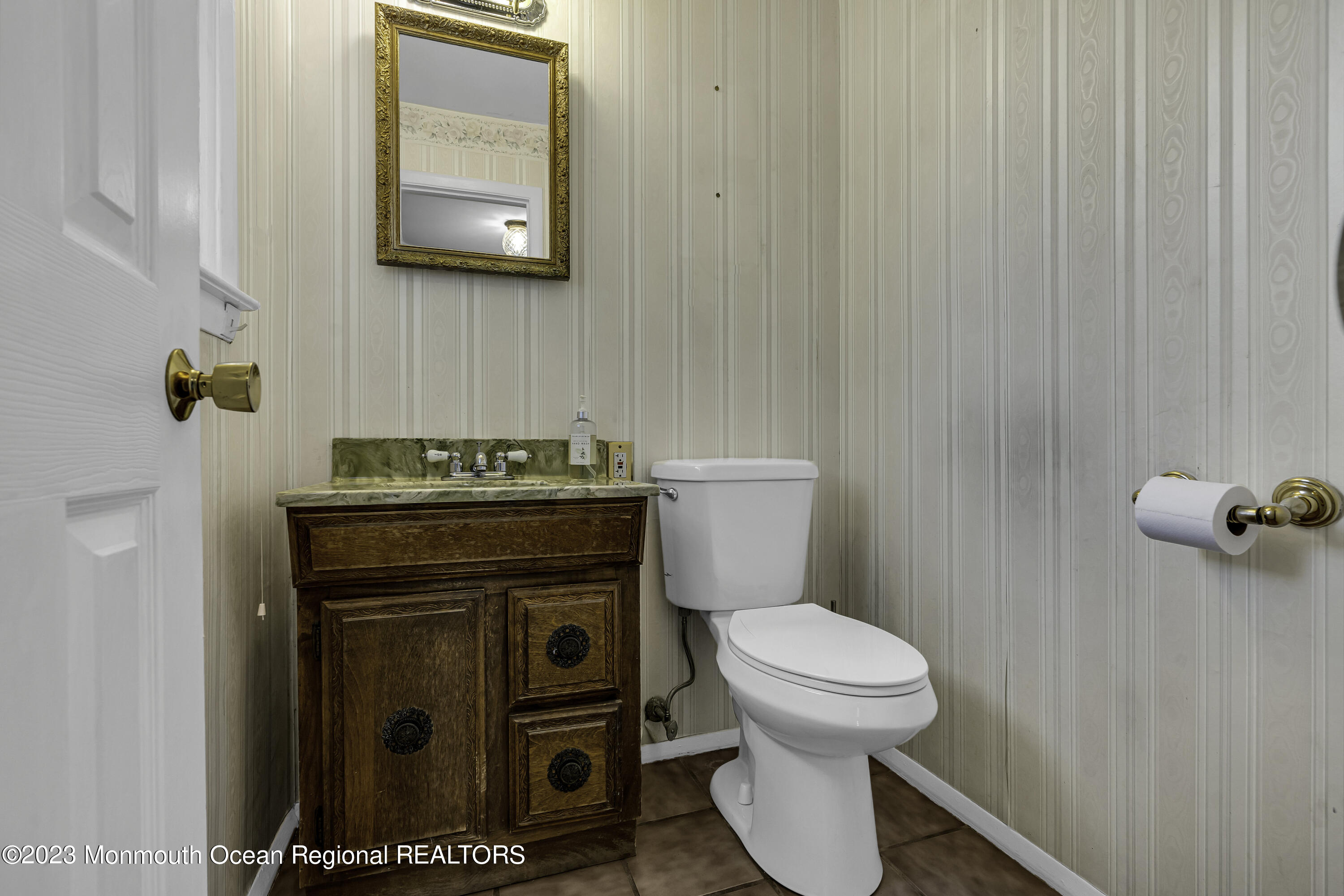 44 Danemar Drive Matawan, NJ 07747 - Photo 7 of 31 a bathroom with a toilet a sink and mirror