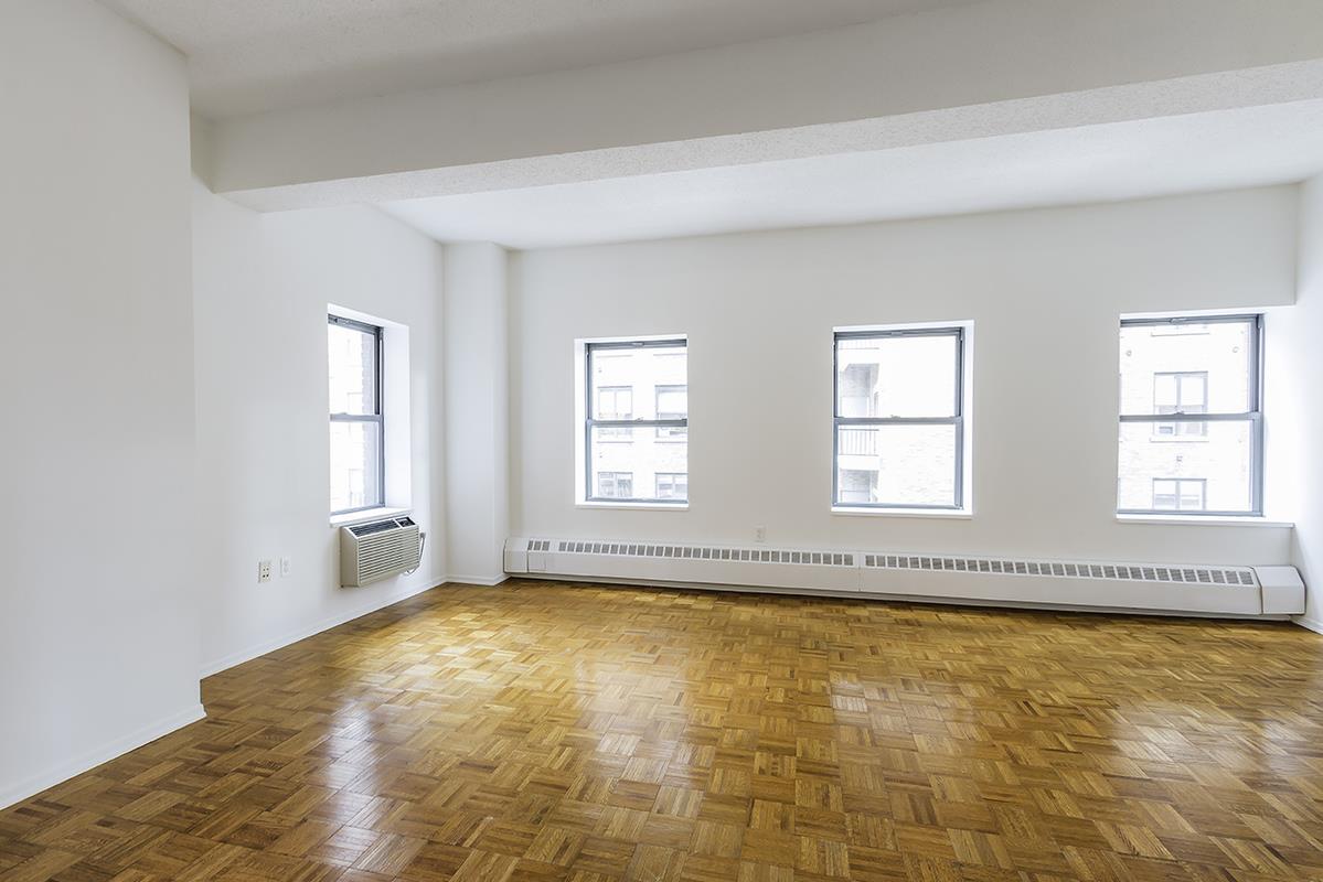 a view of an empty room with windows
