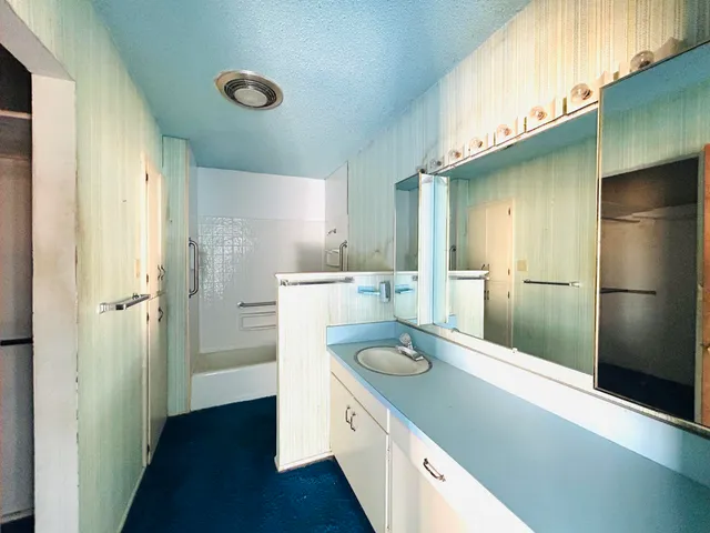 a kitchen with a refrigerator and a sink