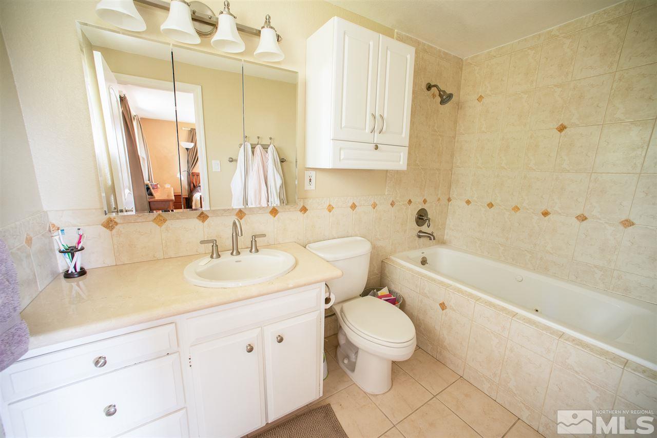 2480 Trentham Way Reno, NV 89509 - Photo 14 of 27 a bathroom with a double vanity sink mirror toilet and bathtub