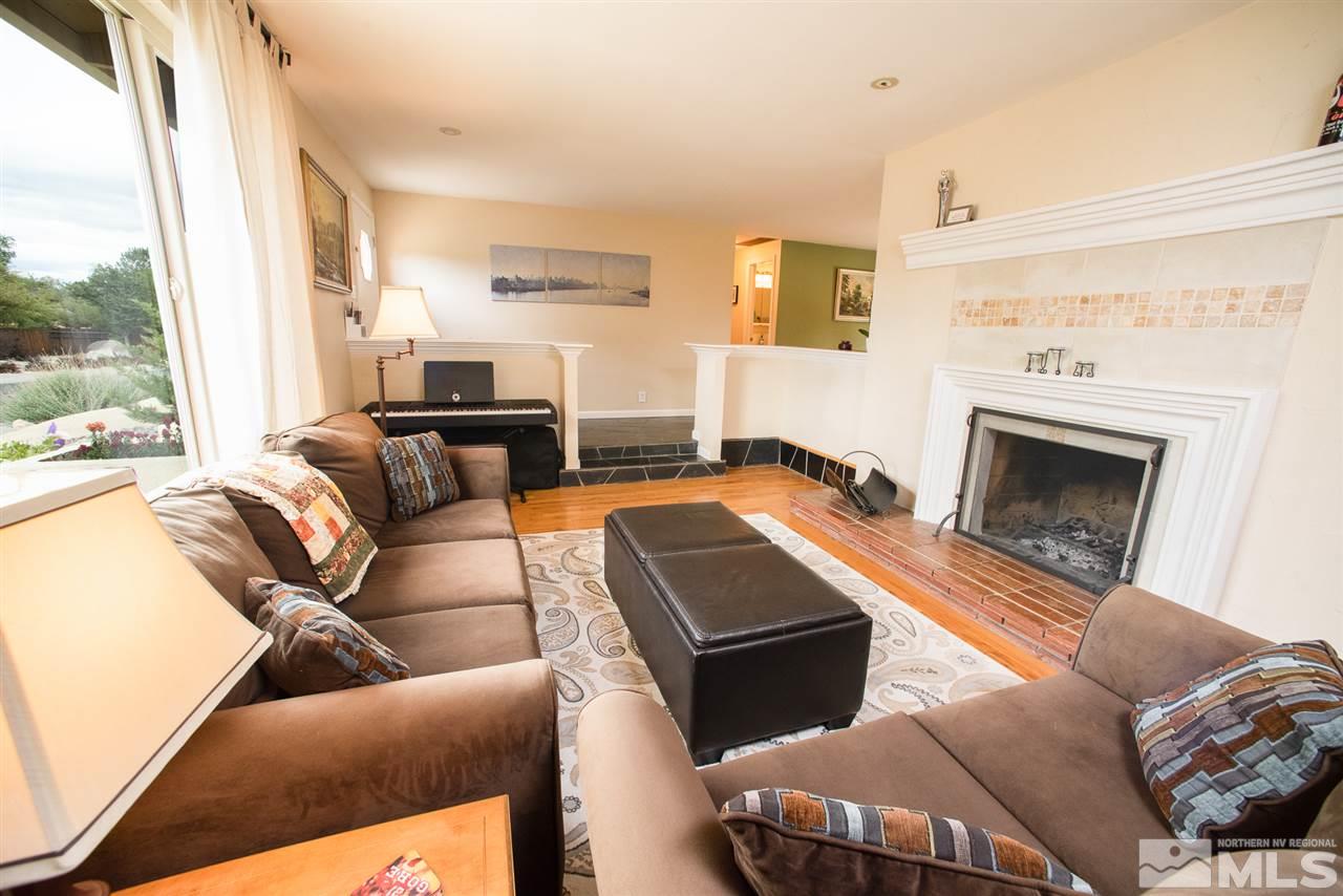 2480 Trentham Way Reno, NV 89509 - Photo 5 of 27 a living room with furniture fireplace and a large window