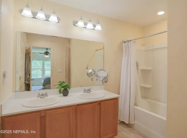 a bathroom with a sink double vanity and a mirror