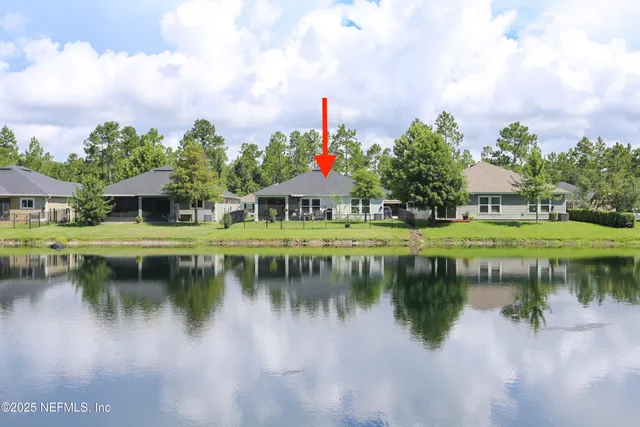 a house view with outdoor space and lake view