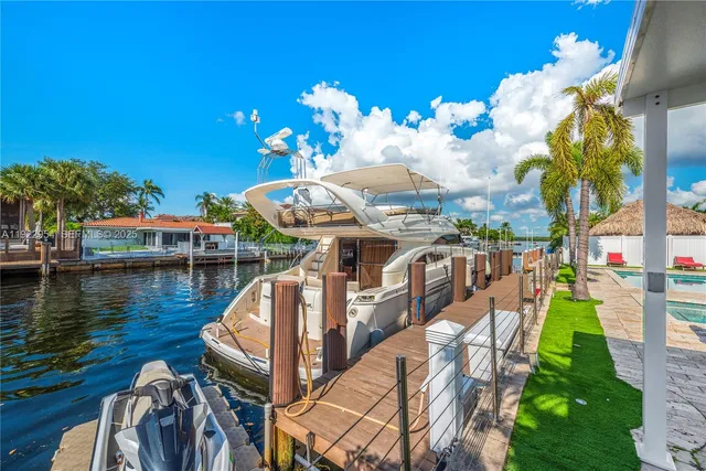 a dining room with furniture and a floor to ceiling window
