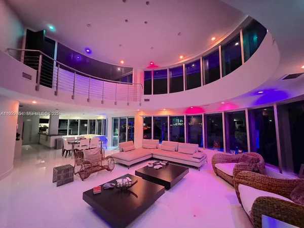 a living room with furniture and a floor to ceiling window