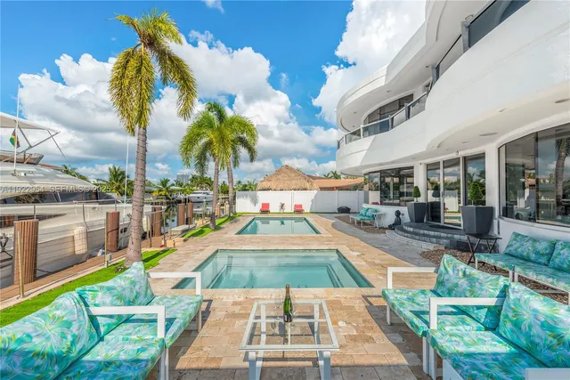 a view of a dining room with furniture and front view of a house