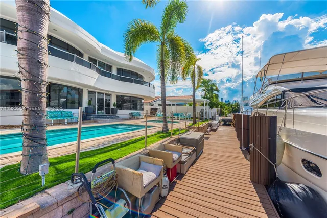 a view of a patio with table and chairs potted plants